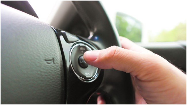 How does adaptive cruise control reduce highway driving fatigue?